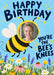 A yellow and black bumblebee holds a round face photo frame above a meadow of daisies and colourful wildflowers, with navy brush wording on sky blue.