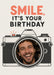 A detailed black line-drawn vintage camera holds a circular photo in its lens, beneath bold coral and black block lettering on cream.
