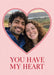 A red double outline frames a heart-shaped photo on pink, above large red serif wording.
