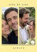 Two tall photos sit side by side on soft yellow, with a fine navy scalloped line below and small spaced serif wording.