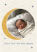 An ochre crescent moon curves around a circular photo on cream, with tiny navy stars and understated navy serif wording.