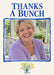 A blue brushstroke border frames a large photo on cream, with blue serif thank-you wording above and a small yellow bouquet tied with a blue bow below.