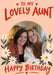 Lovely Aunt birthday photo card with cream flowers, green leaves, a peach background and red lettering, shown with two smiling women sitting together at home.